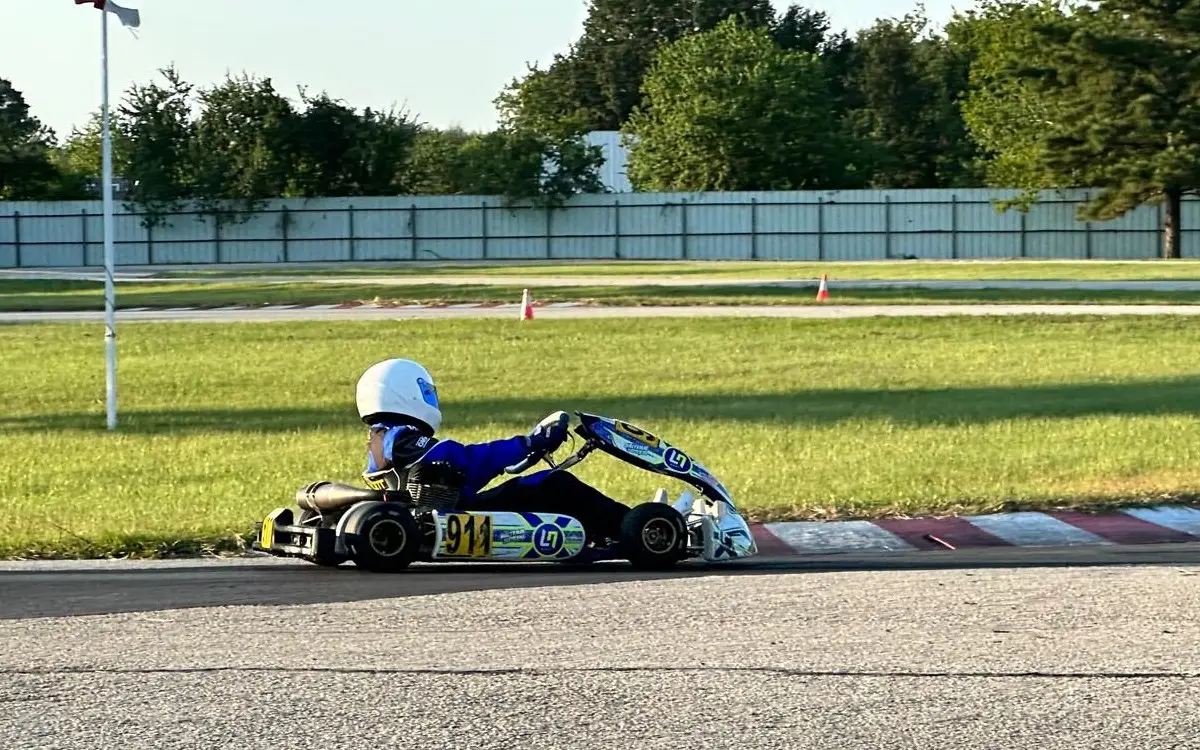 Kavin racing a go-kart through a corner, number 911.